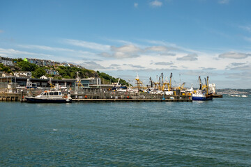 Obraz premium Colourful houses overlooking the harbour in the seaside town of Brixham on the Devon coast