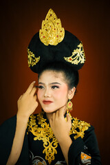 young asian women wearing makeup, wearing batik clothes and Indonesian cultural attributes
