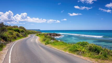 A road with a beautiful ocean view in the background. The road is empty and the sky is clear