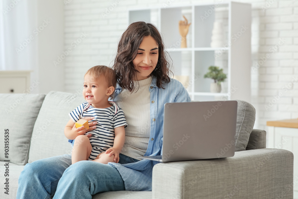 Sticker cute baby and happy young mother working with laptop on maternity leave at home