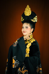 young asian women wearing makeup, wearing batik clothes and Indonesian cultural attributes