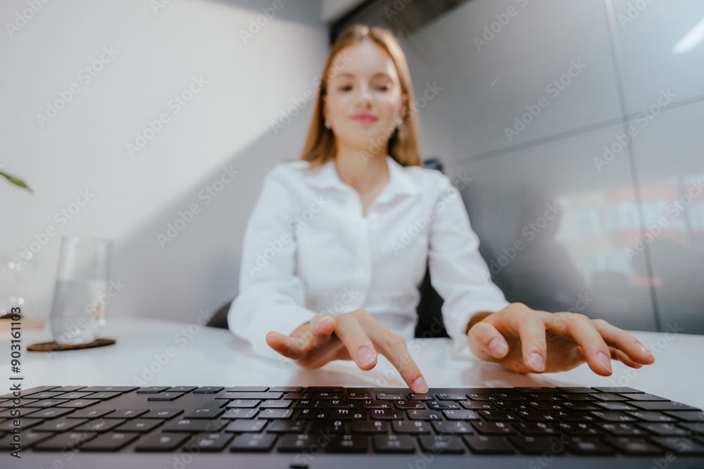 Wall mural woman typing on keyboard in office