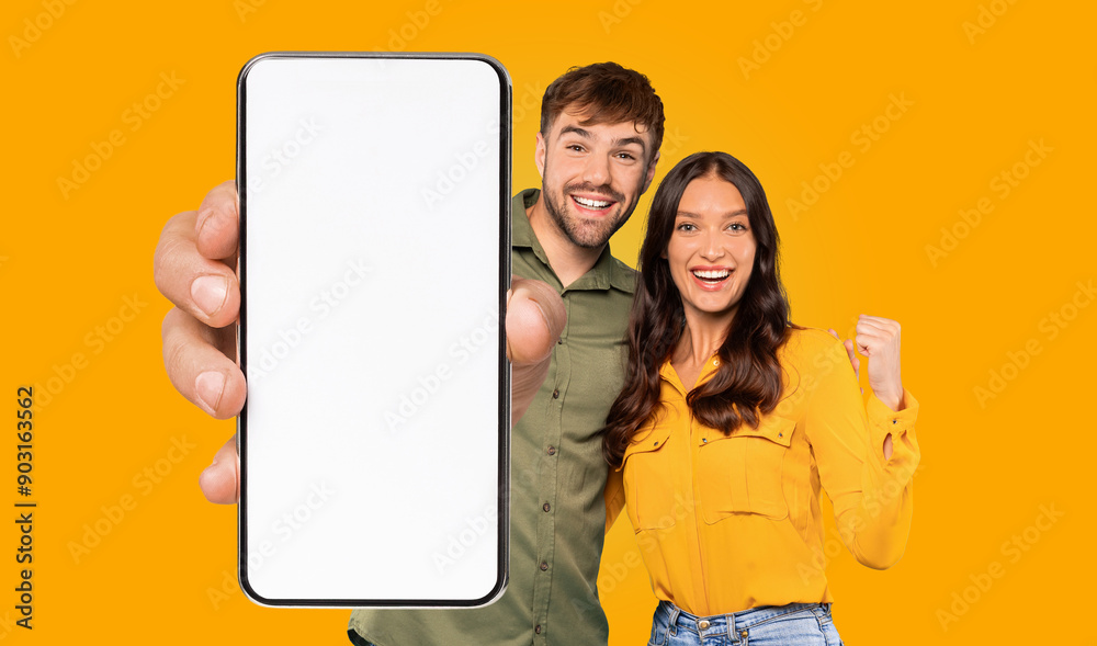 Poster a happy couple is holding a smartphone with a blank white screen, and they are both pointing at the 