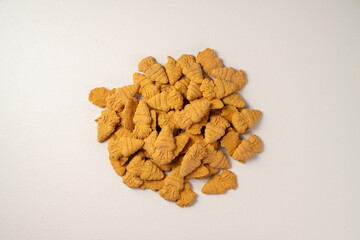 Treat for bunnies. Dry snack, carrot shaped food for pets.