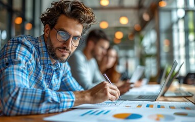 A financial consultant meticulously reviews charts and graphs while collaborating with colleagues in a trendy office environment
