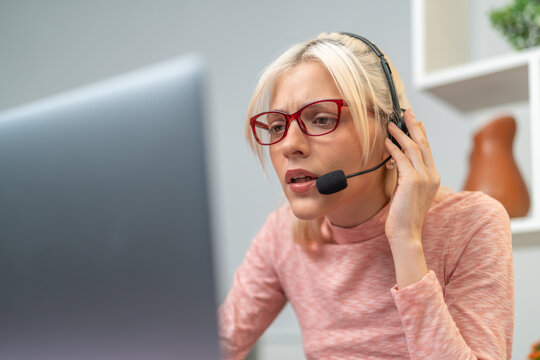 Telemarketer woman working from home having a difficult phone call