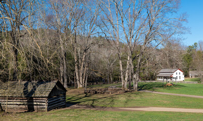 Old buildings and trees at a Cades Cove historic area in the Great Smokey Mountains.