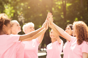 Oncology Volunteers. Smiling Breast Cancer Patients In Pink T-Shirts Giving High Five During Support Group Meeting Outdoors. Selective Focus
