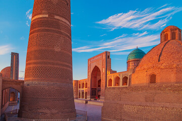 Poi Kalyan architectural ensemble - minaret, madrasah and mosque at sunset.