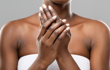 Skin nutrition concept. Unrecognizable african american woman applying moisturizing cream to her...