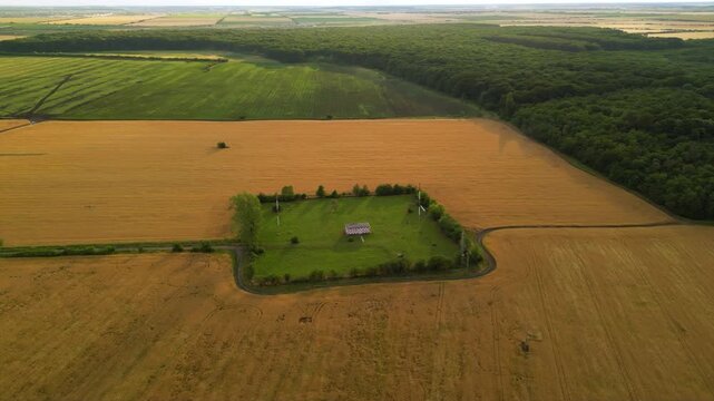 Drone footage of ILS system marker beacon near an international airport. High angle shot of rural field with 75Mhz antenna for landing approach guidance and assistance of airplanes. VFR Radio
