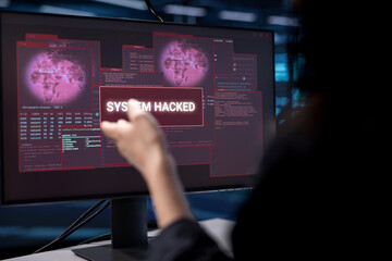 Admin in server hub establishment frightened by hacker passing firewall and stealing data. Close up shot of security breach notification on monitor in data center making IT expert panic