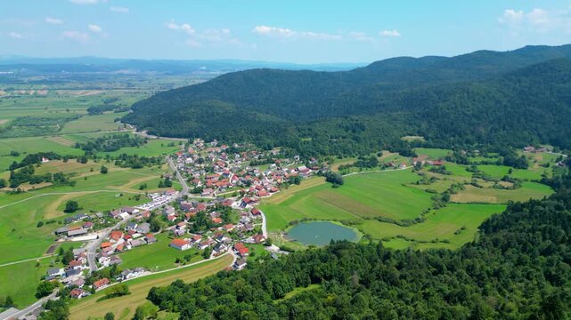 A stunning aerial view of Cerkev sv. Ane, Jezero, and Jezero pri Podpeči in Slovenia, captured by a drone. This captivating image showcases the picturesque church of St. Anne, serene lakes