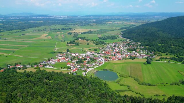 A stunning aerial view of Cerkev sv. Ane, Jezero, and Jezero pri Podpeči in Slovenia, captured by a drone. This captivating image showcases the picturesque church of St. Anne, serene lakes