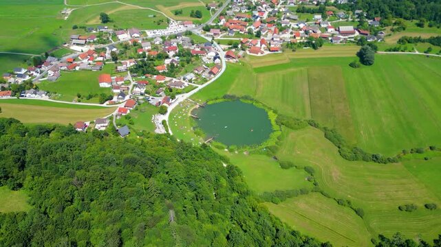 A stunning aerial view of Cerkev sv. Ane, Jezero, and Jezero pri Podpeči in Slovenia, captured by a drone. This captivating image showcases the picturesque church of St. Anne, serene lakes