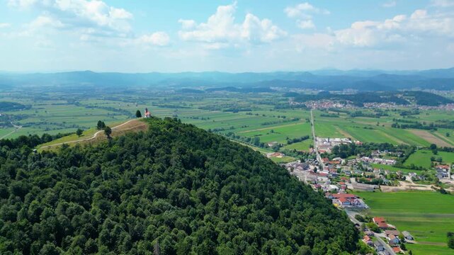 A stunning aerial view of Cerkev sv. Ane, Jezero, and Jezero pri Podpeči in Slovenia, captured by a drone. This captivating image showcases the picturesque church of St. Anne, serene lakes