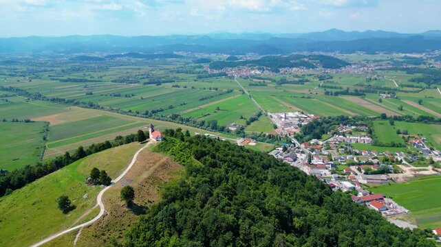 A stunning aerial view of Cerkev sv. Ane, Jezero, and Jezero pri Podpeči in Slovenia, captured by a drone. This captivating image showcases the picturesque church of St. Anne, serene lakes