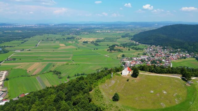 A stunning aerial view of Cerkev sv. Ane, Jezero, and Jezero pri Podpeči in Slovenia, captured by a drone. This captivating image showcases the picturesque church of St. Anne, serene lakes