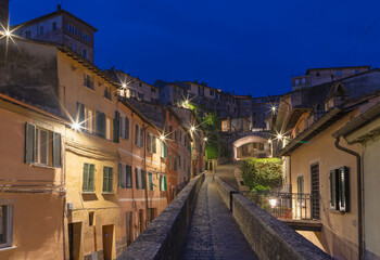 Perugia - The aqueduct and old town at dusk.