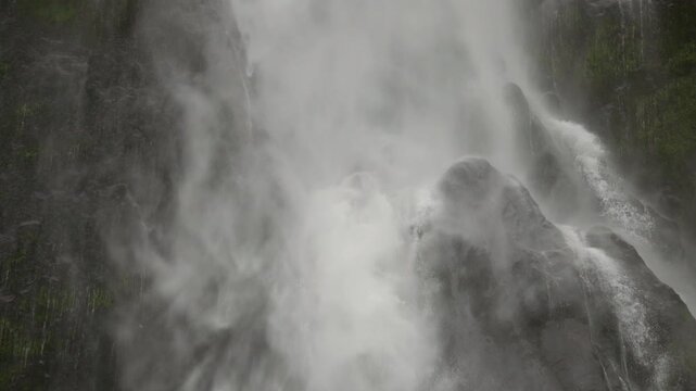 A close up on a section of Sutherland Falls as water cascades through the frame