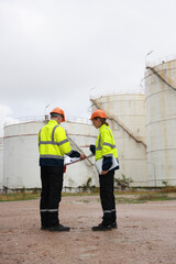 The senior manager female engineer and her male colleague are confidently working together at an...