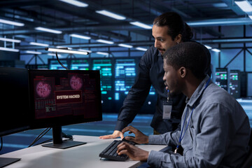 Computer scientists in server hub workspace frightened by hacker passing firewall and stealing data. Security breach notification on monitor in data center surprising IT specialists
