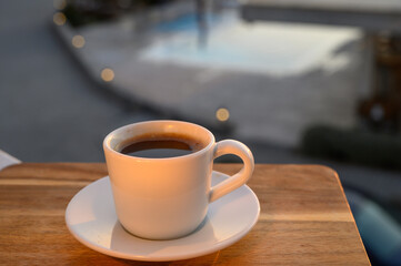 a cup of black Turkish coffee on the balcony at sunset