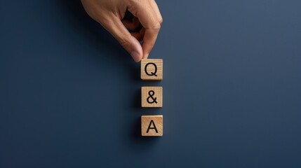 Customer support concept, Q&A cube wooden block on blue background for question and answer.