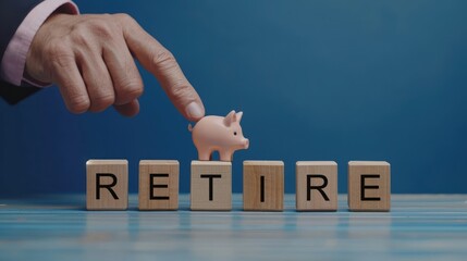 Retirement concept, Hand pick the retire cube wooden block and piggy on the table.