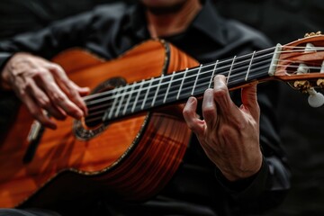 man playing classical guitar at black background