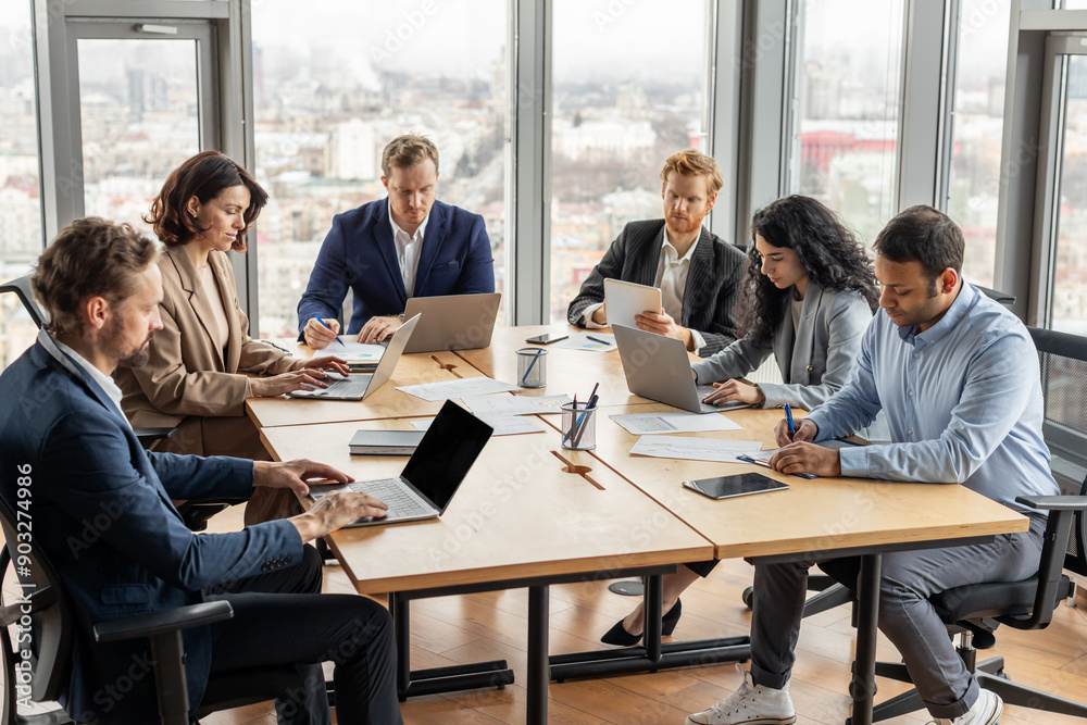 Aufkleber a diverse team of five professionals work together on their laptops in a modern office setting. the 