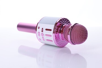 One pink karaoke microphone isolated on white