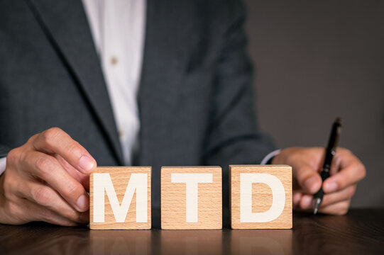 There is wood cube with the word MTD. It is an abbreviation for month to date as eye-catching image.