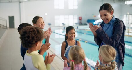 Cheering, children in huddle and swimming instructor woman in gymnasium for celebration or motivation. Applause, milestone and team building with coach clapping for kids at indoor pool of school