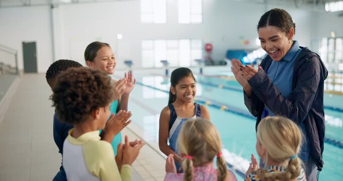 Cheering, children in huddle and swimming instructor woman in gymnasium for celebration or motivation. Applause, milestone and team building with coach clapping for kids at indoor pool of school