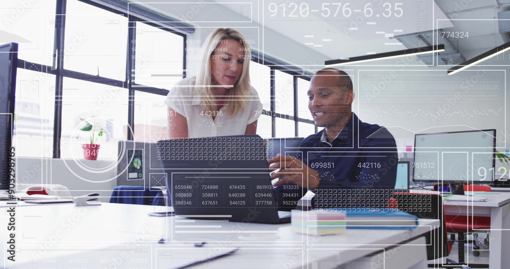 Poster analyzing data and collaborating over digital interface in modern office image