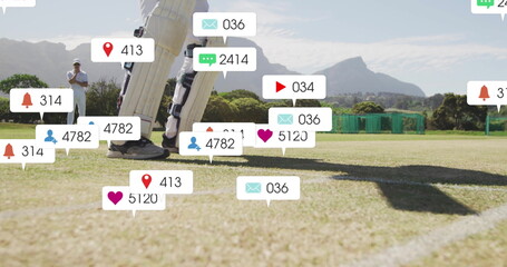Image of social media icons with growing numbers over diverse male cricket players