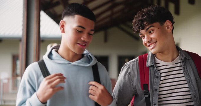 Walking, boys and students with education, conversation for recreational activity, share study tips and chatting. Break, school or teenagers in hallway, discussion for planning and friends with smile
