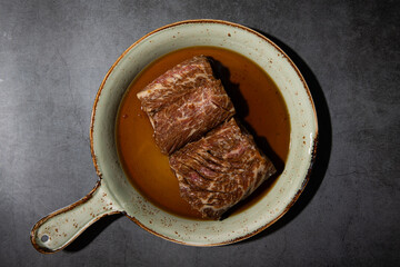 raw galbi in sauce on a plate