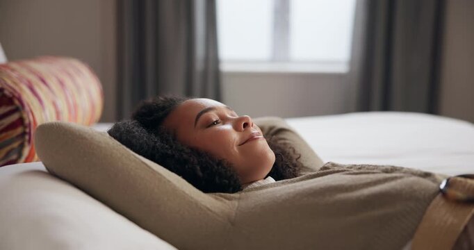 Woman, lying down and bed to relax at house from work fatigue, peace and comfort with nap for wellness. Smile, female person and rest in bedroom on pillow for sleep, tired and calm morning at home