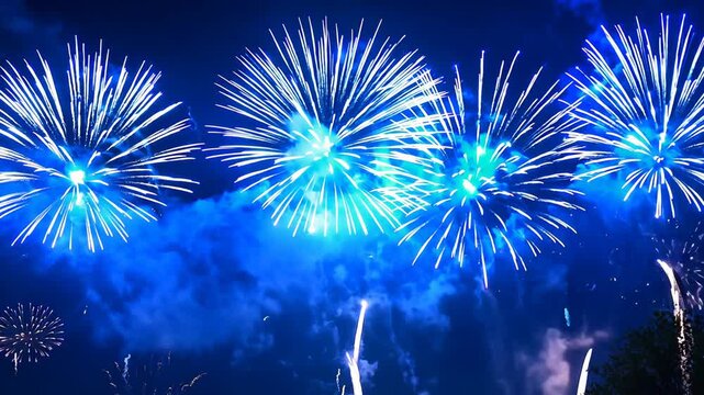 Bright blue fireworks display in night sky