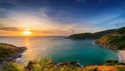 Fototapeta premium A breathtaking sunset over a secluded bay with wind turbines in the distance