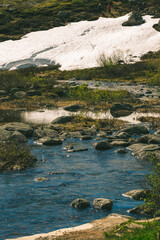 Hiker Exploring Serene Mountain Stream Landscape in Spring.