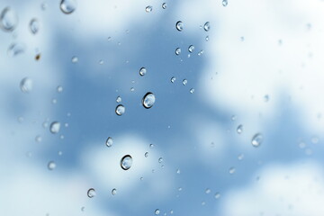 water drop on mirror with blue sky and white cloud background