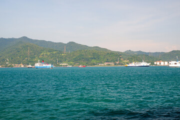 Fototapeta premium view of ships preparing to dock at Merak Banten Port in Sunda Strait