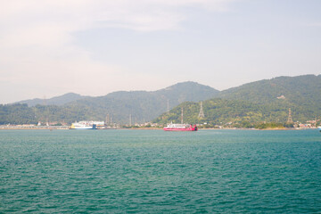 Fototapeta premium view of ships preparing to dock at Merak Banten Port in Sunda Strait