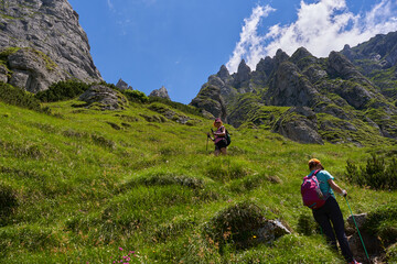 Hiker women with backpacks on a trail
