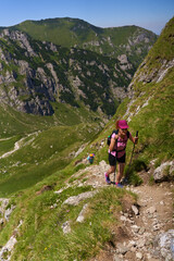 Hiker women with backpacks on a trail