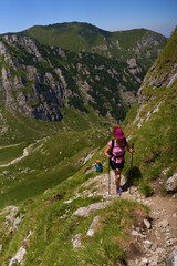 Fototapeta premium Hiker women with backpacks on a trail