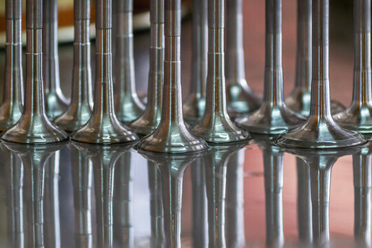 We see beautiful reflections of engine parts, called cylinder head valves or cylinder head, image taken on the workbench of my mechanical workshop, San Martin Mendoza Arg.
